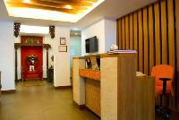 the reception desk with the tile inlays and woven cane fascia.